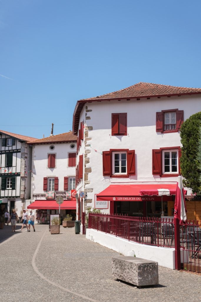 White buildings with red shutters in Espelette