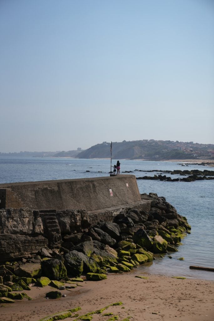 Small sandy cove beside Guéthary's harbor wall