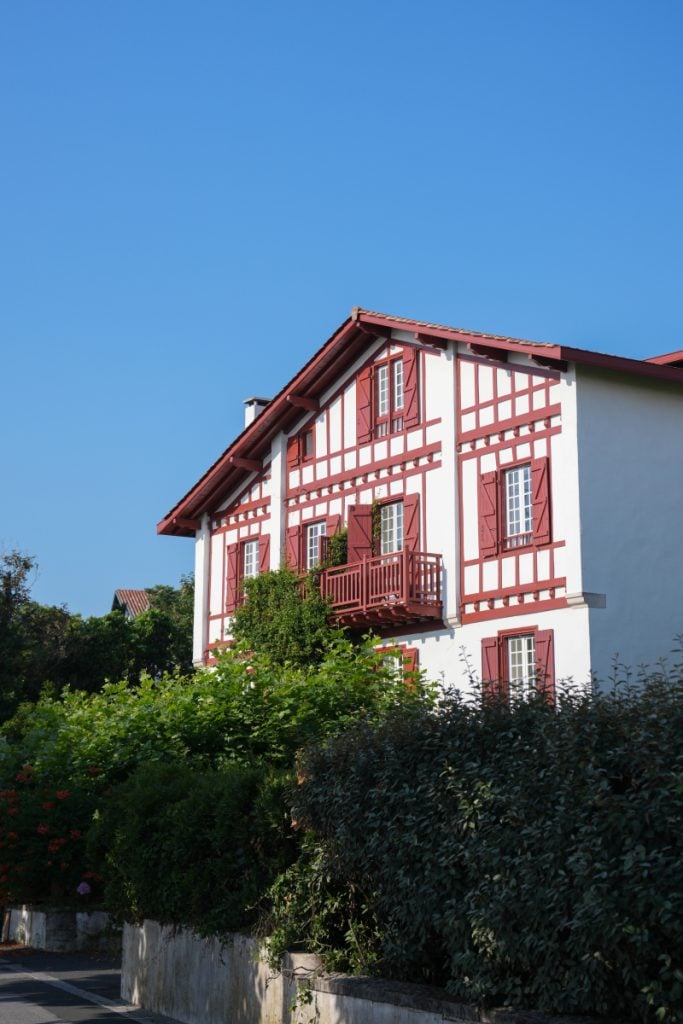 Villa Catarie exterior with red shutters and garden