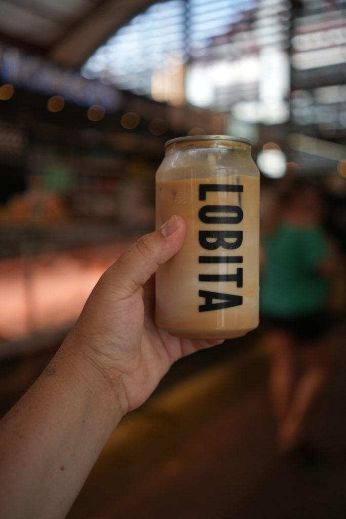 Hand holding a Lobita canned iced coffee