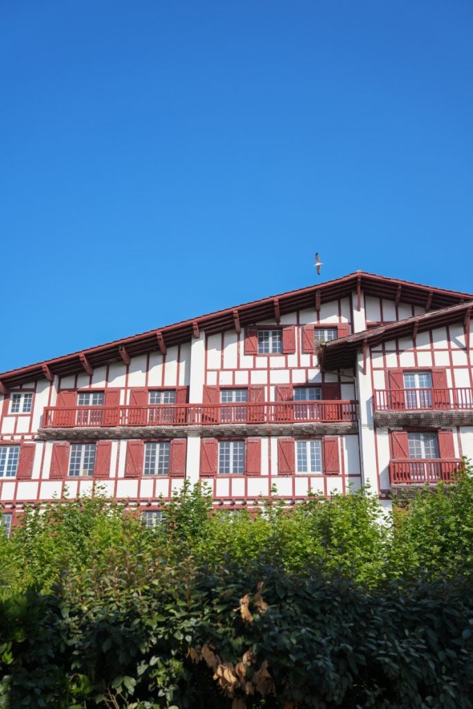 Basque-style building with red shutters in Guéthary