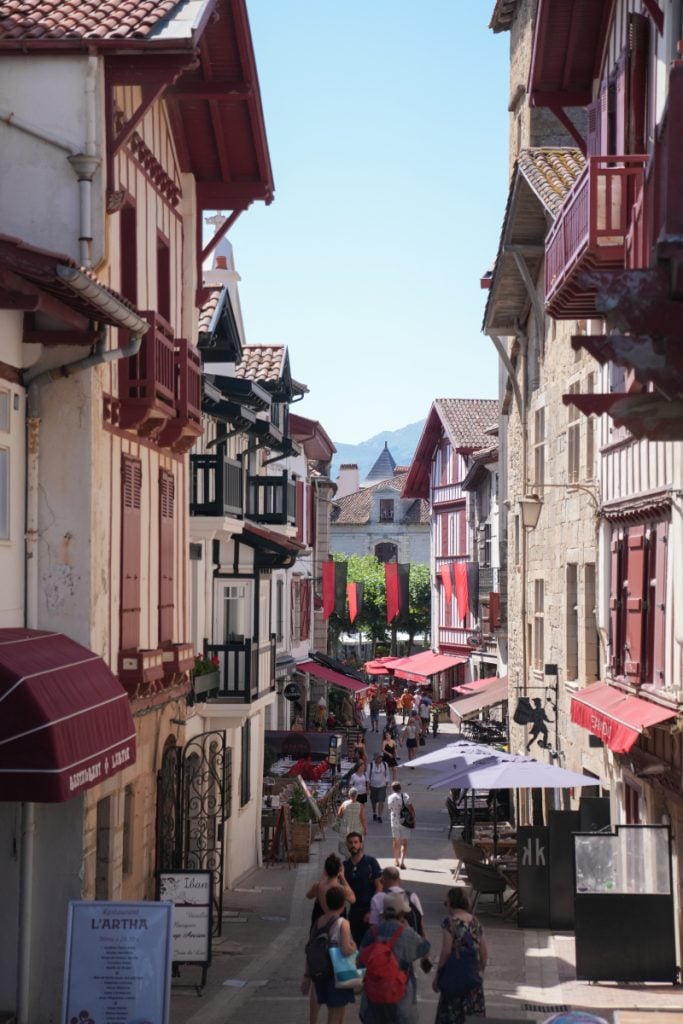 Narrow pedestrian street lined with cafés in Saint-Jean-de-Luz