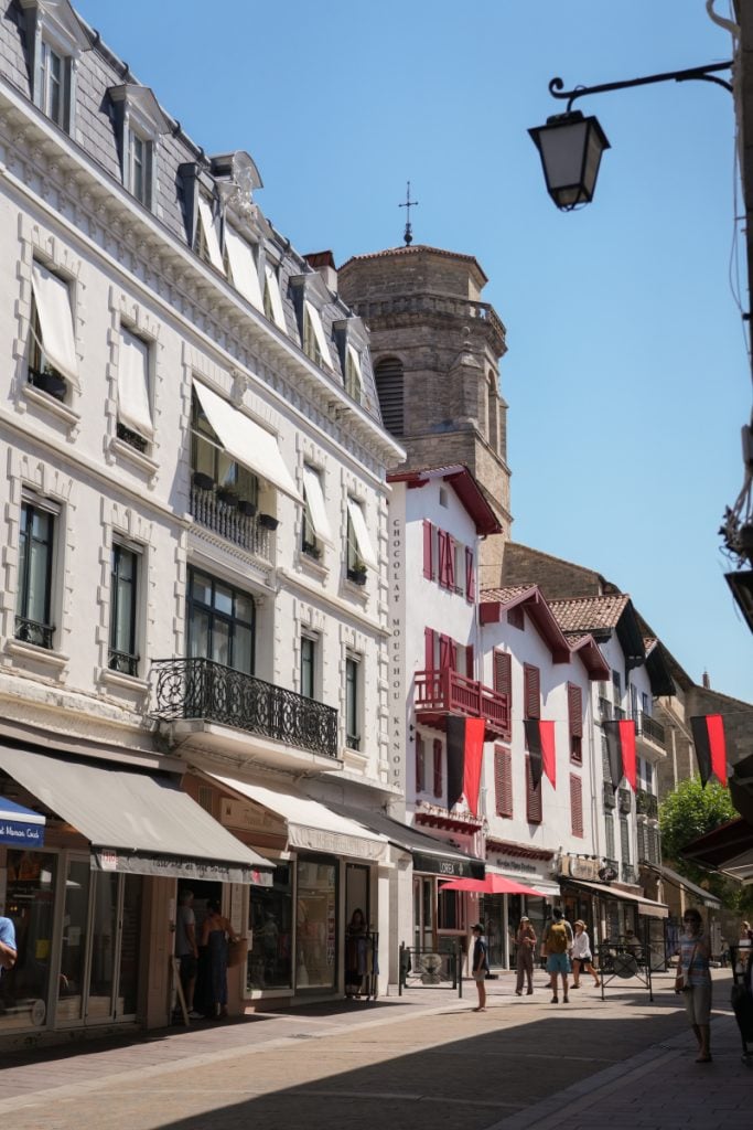 Shopping street and church tower in Saint-Jean-de-Luz