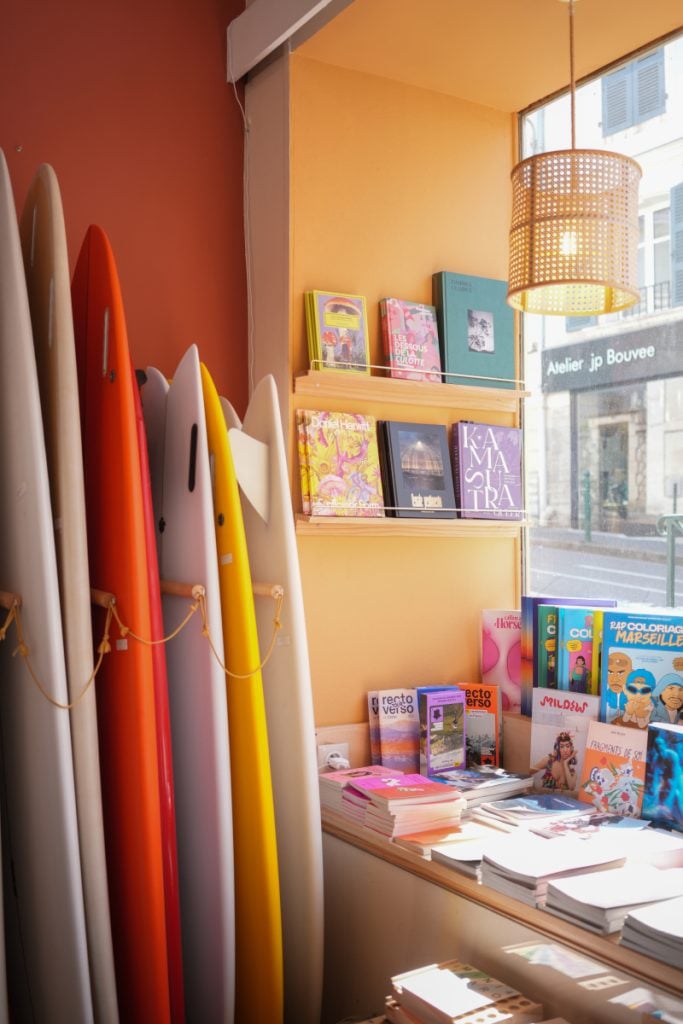 Surfboards and books inside Colors of Surfing