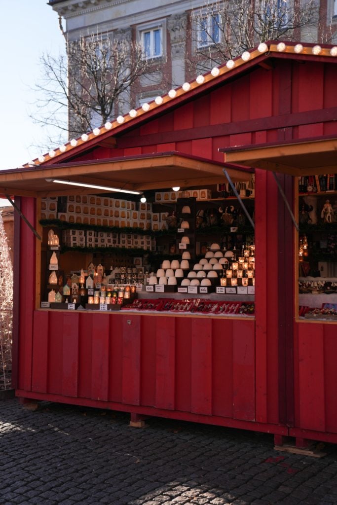 Red market stall selling illuminated Christmas decorations