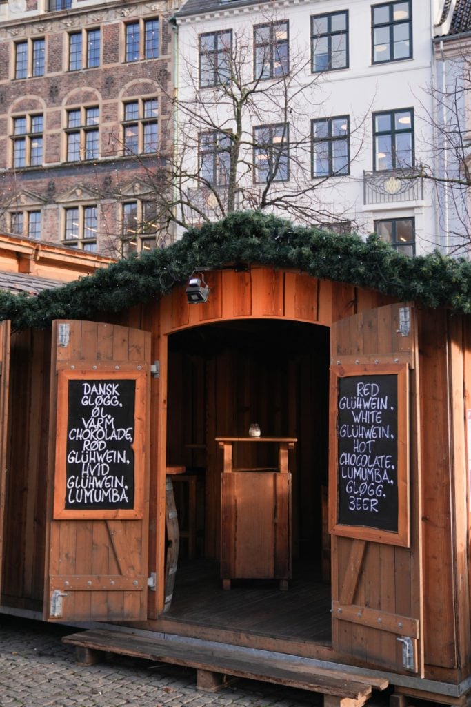 Wooden Christmas market drink stall with chalkboard menus