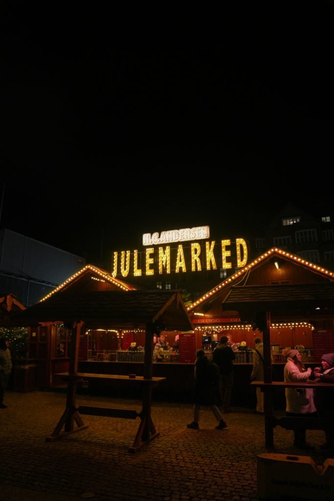 Illuminated H.C. Andersen Christmas Market stalls at night