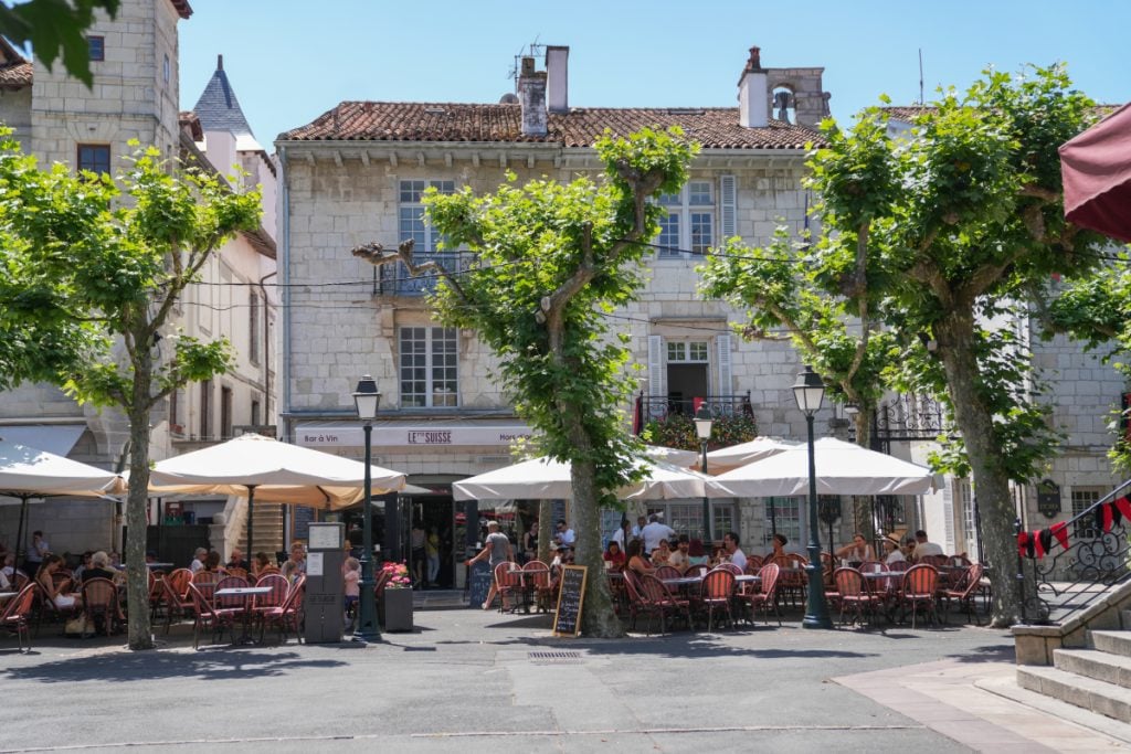 Tree-lined café terraces at Place Louis XIV