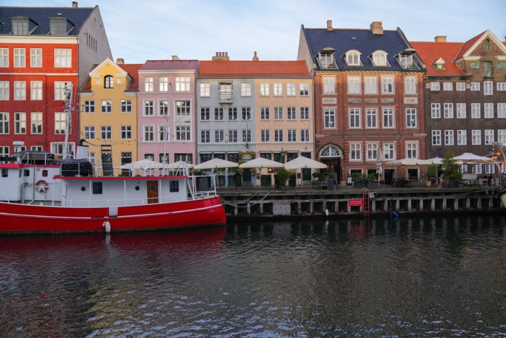 Red boat beside colorful buildings along Copenhagen’s Nyhavn canal