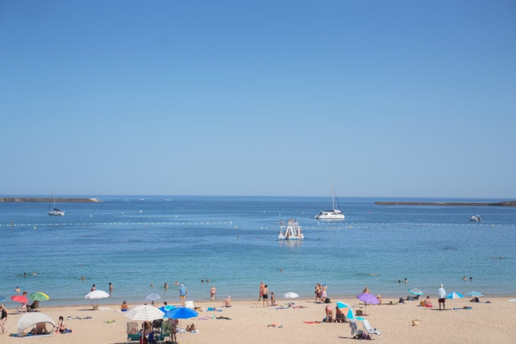 Beachgoers and sailboats at Grande Plage in Saint-Jean-de-Luz