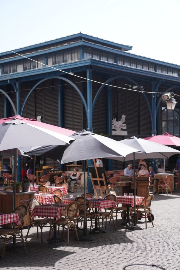 Outdoor café tables beside Les Halles market
