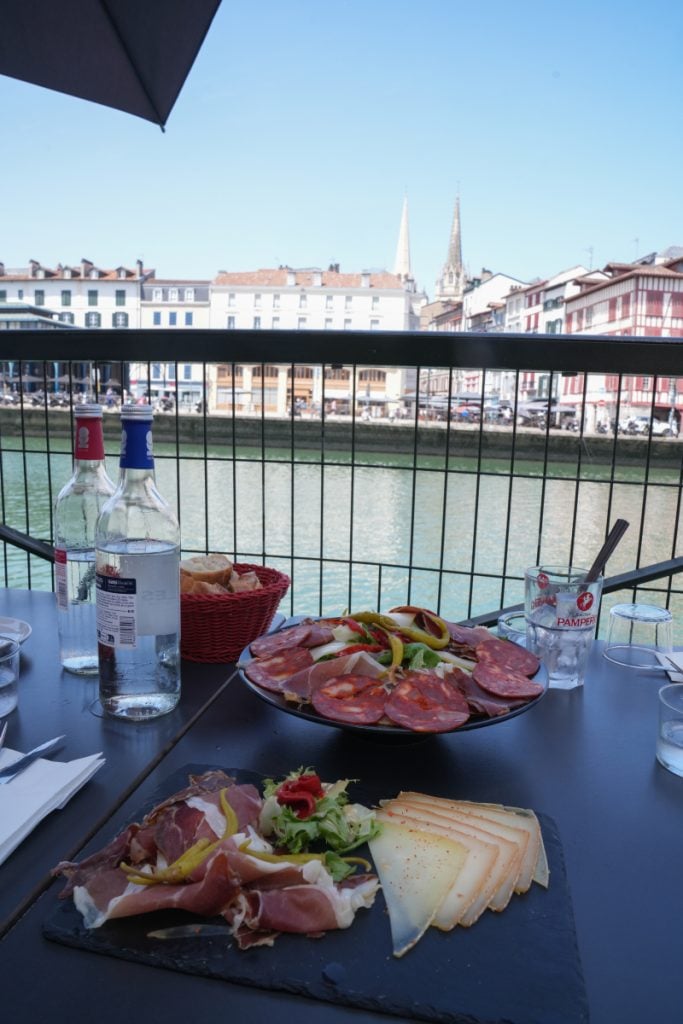 Charcuterie and cheese on a riverside table in Bayonne
