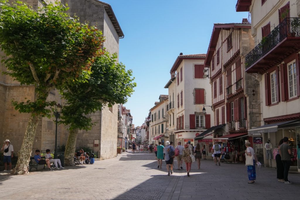 Pedestrians and shops along a Saint-Jean-de-Luz Old Town street