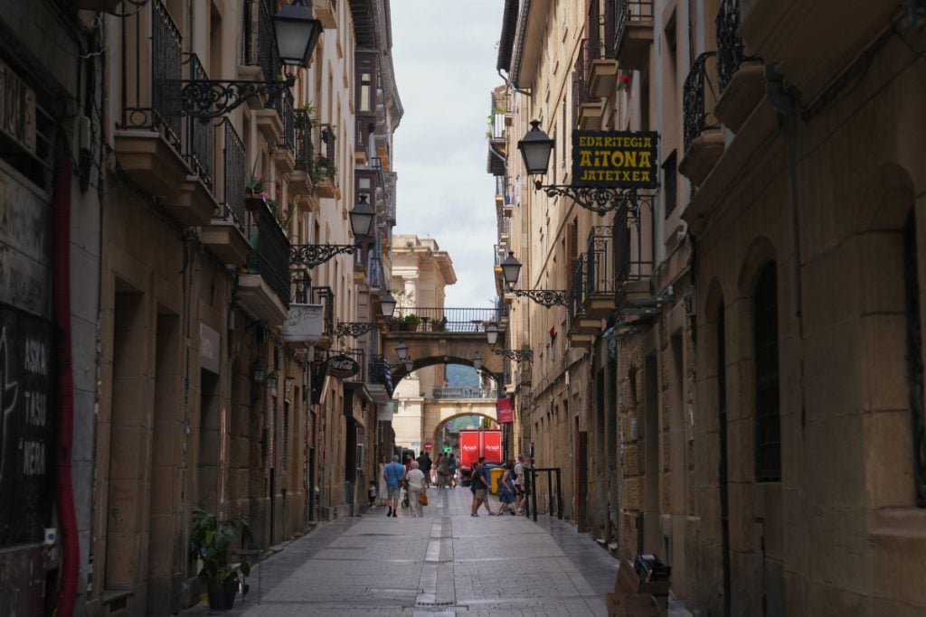 Pedestrians on a narrow street in Parte Vieja