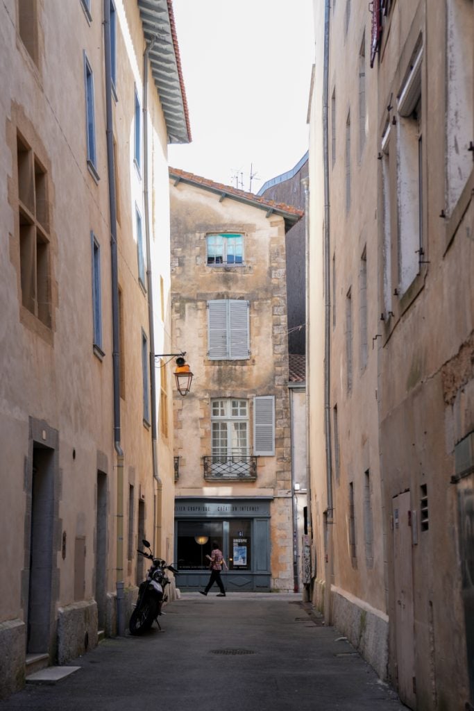 Narrow street lined with shuttered buildings in Petit Bayonne