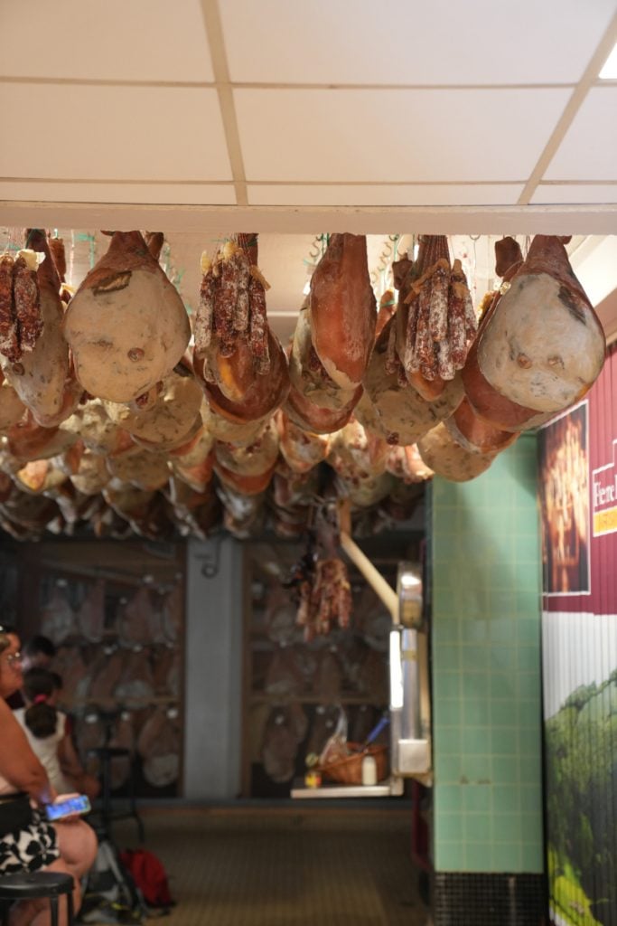 Rows of curing hams hanging at Pierre Ibaïalde
