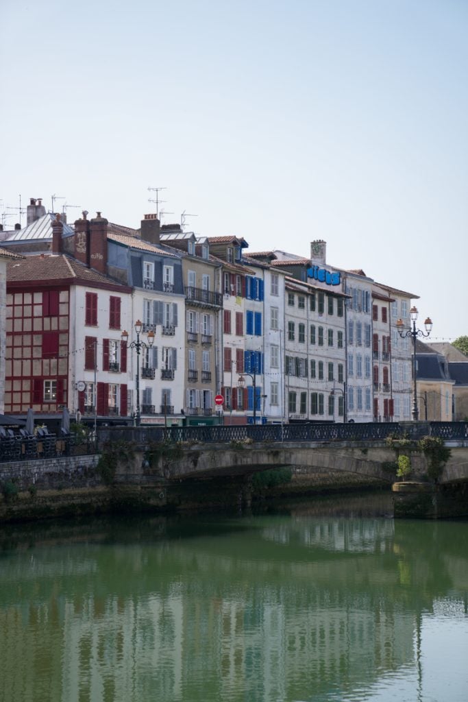 Colorful buildings lining the Nive River in Bayonne