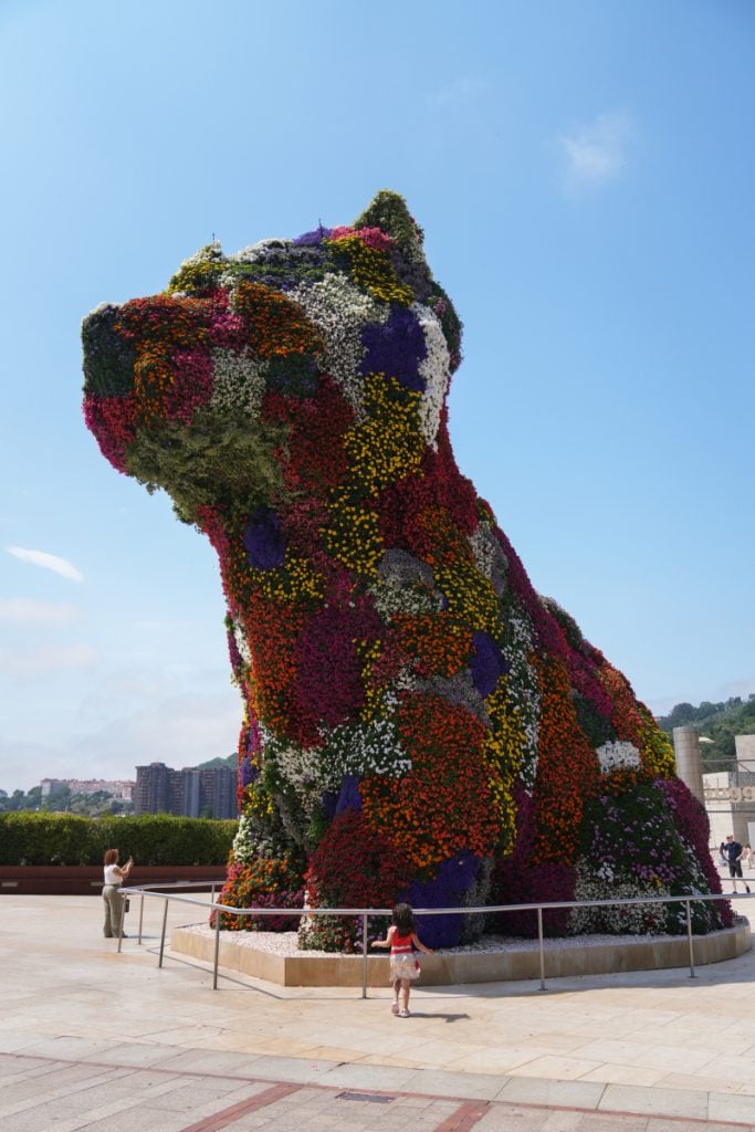 Flower-covered Puppy sculpture outside the Guggenheim Museum