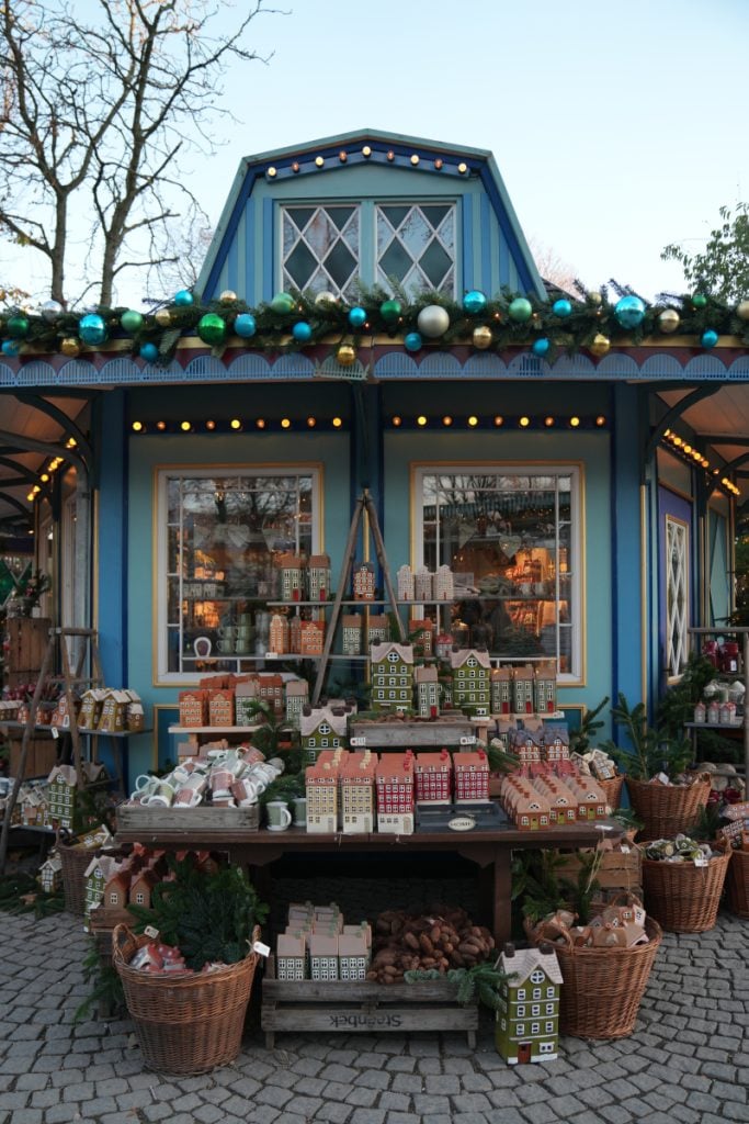 Christmas market stall displaying ceramic houses at Tivoli