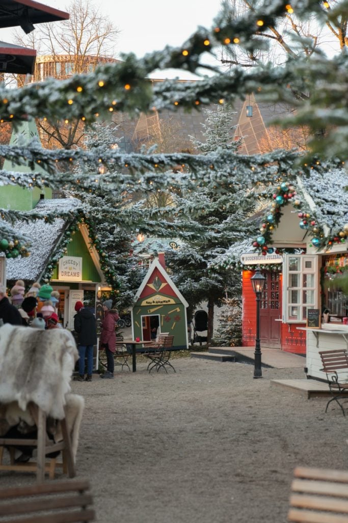 Snow-dusted Christmas stalls and evergreens at Tivoli Gardens