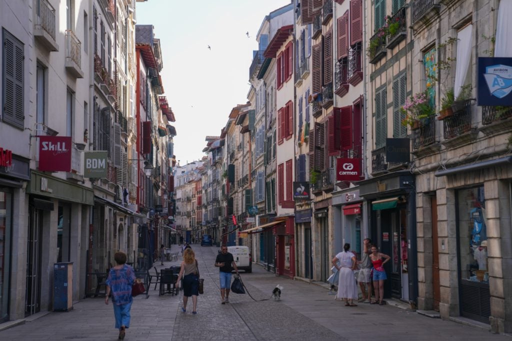 Pedestrians on a shop-lined street in Grand Bayonne