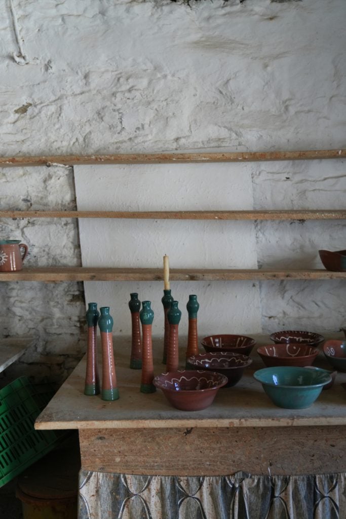 Ceramic bowls and candlesticks in a Sifnos pottery studio