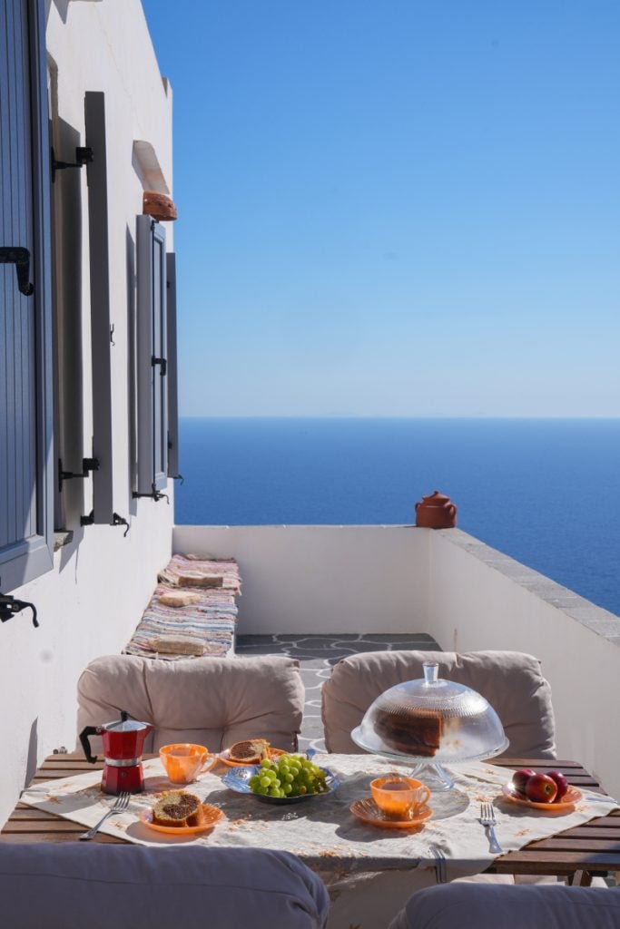 Breakfast table on the sea-view terrace at Aggelis Villa near Artemonas.