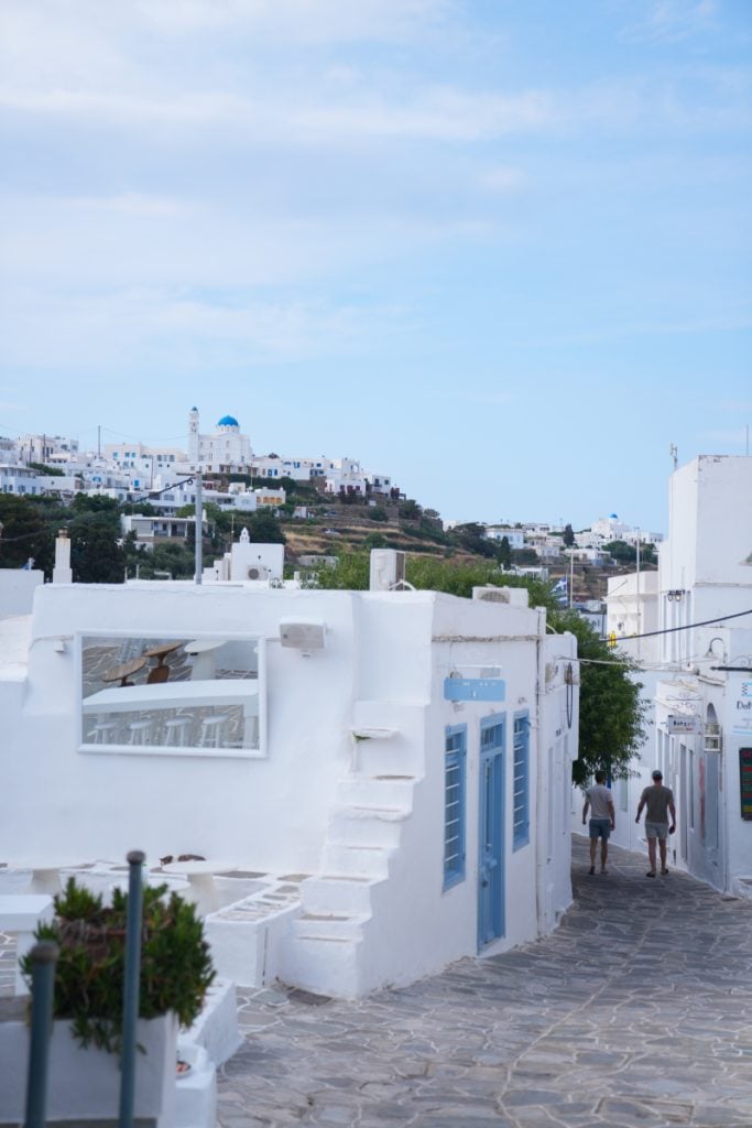 Whitewashed Apollonia lane overlooking hillside homes and churches