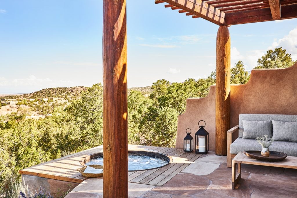 Private terrace with an outdoor soaking tub and cushioned seating