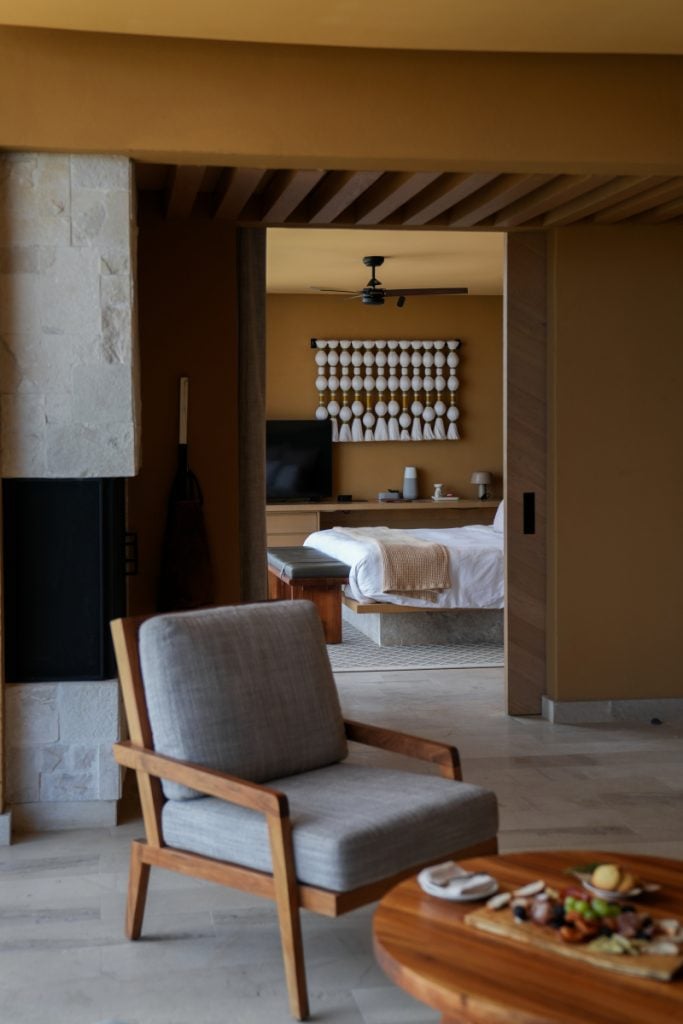 Earth-toned Banyan Tree Veya suite with fireplace and bedroom