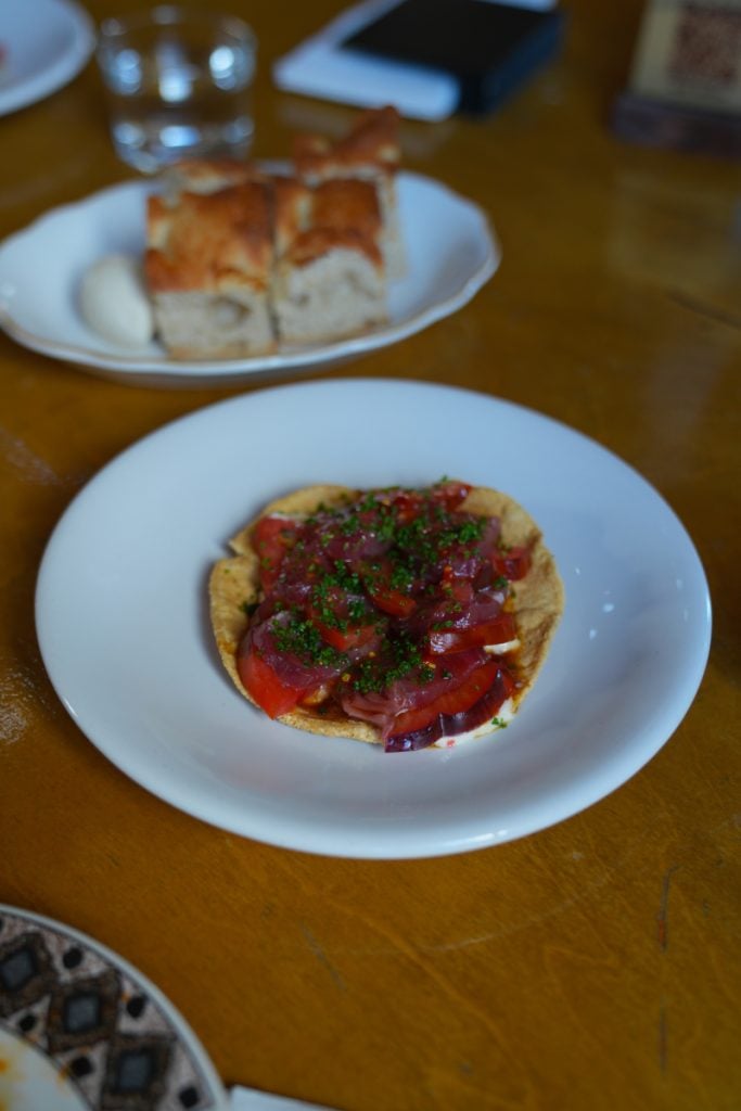 Tuna tostada and bread served at BloodLust Winebar