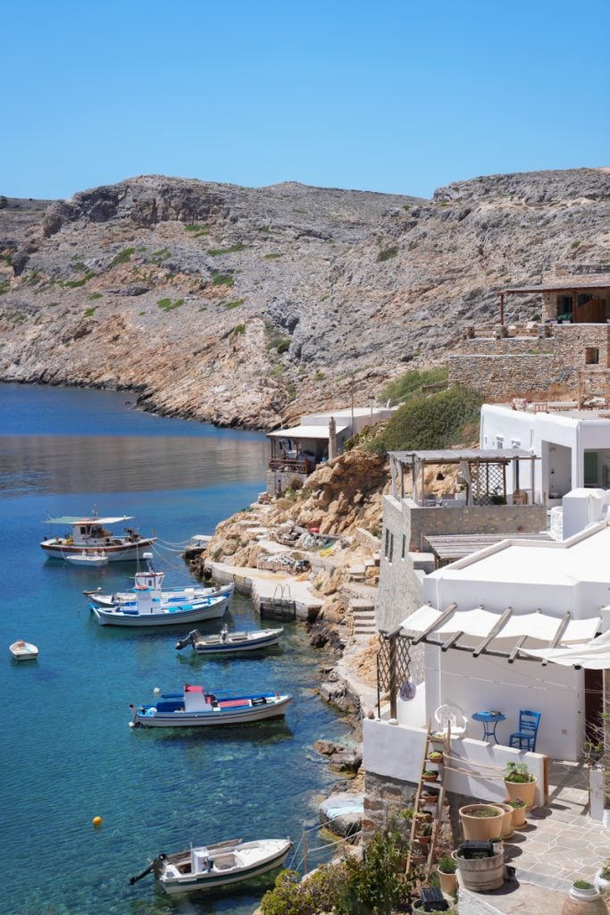 Fishing boats moored beside the white waterfront homes in Cheronissos.