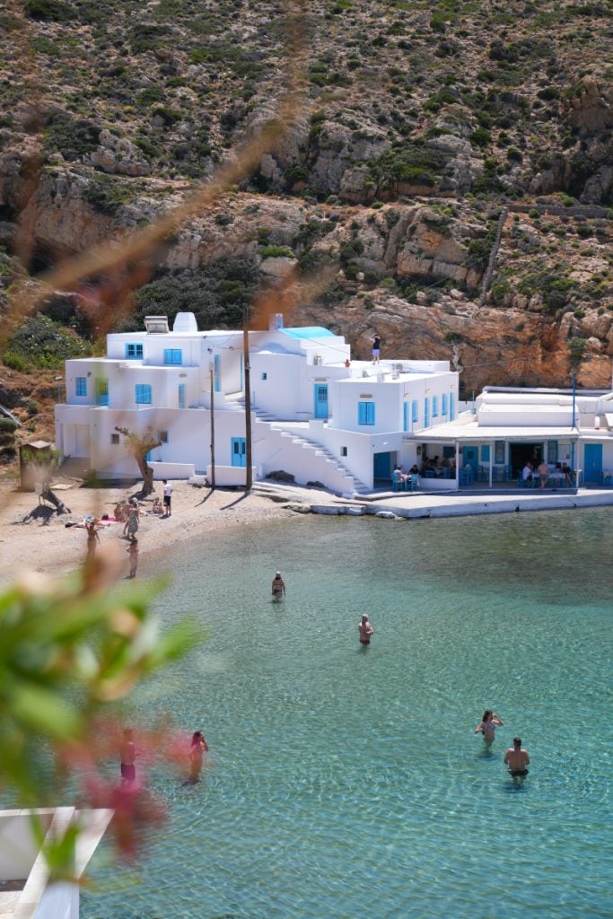 Swimmers in turquoise water at Cheronissos Beach