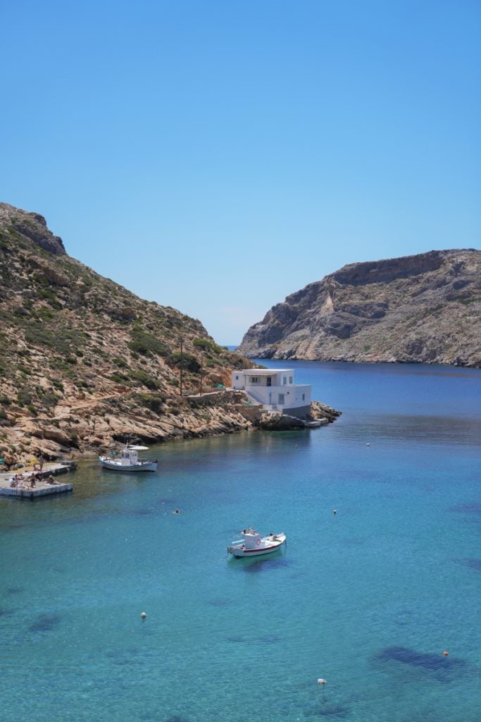 Small boats in the sheltered turquoise inlet at Cheronissos.