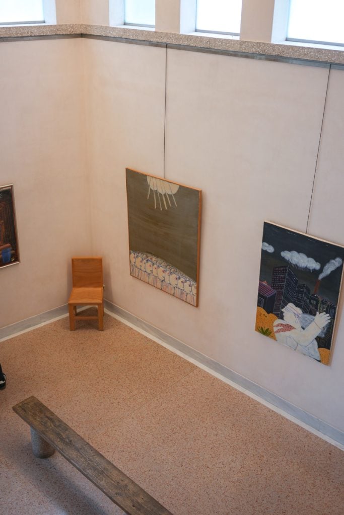 Paintings and wooden seating inside the Alekos Fassianos Museum