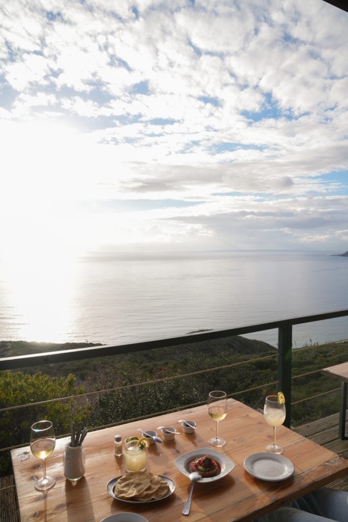 Drinks and appetizers overlooking the ocean at Bar Bura