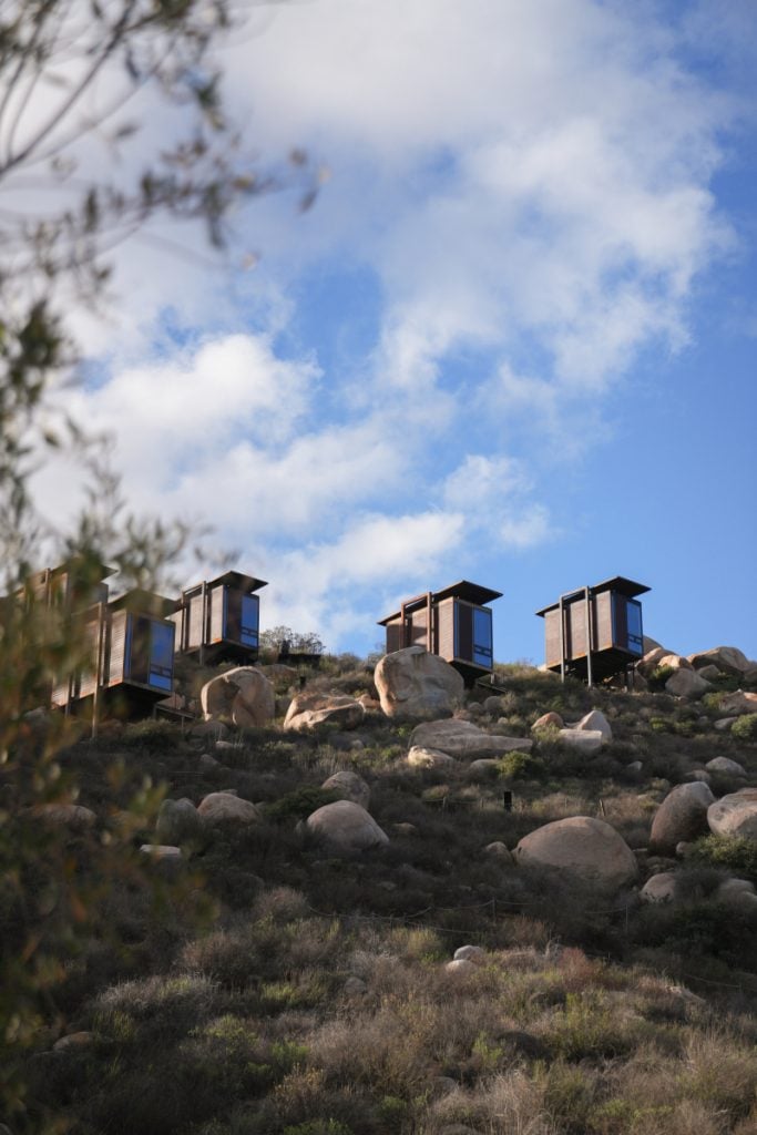 Encuentro Guadalupe cabins perched on a rocky hillside