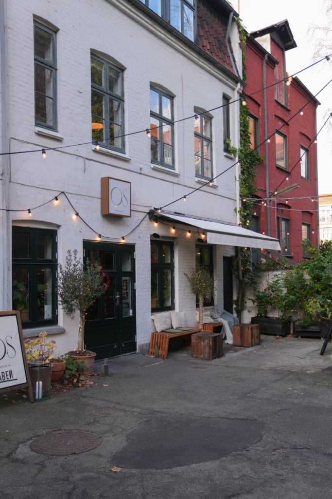 String lights above a courtyard storefront in Frederiksbjerg
