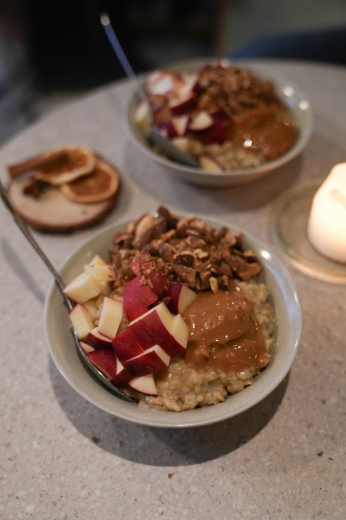 Porridge topped with apples, nuts, and caramel at GRØD