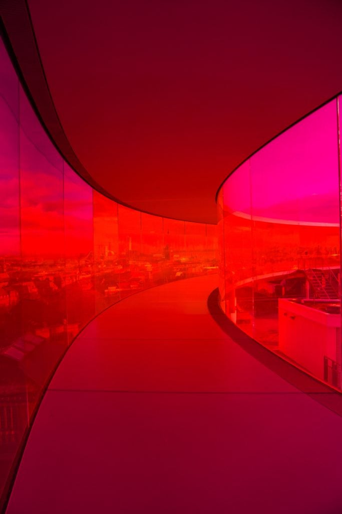 Curved red and pink glass walkway at ARoS Museum