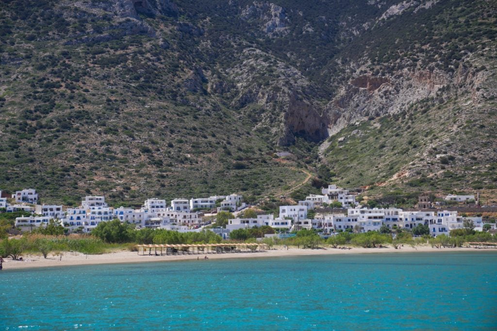 Kamares Beach and whitewashed village beneath rocky hills