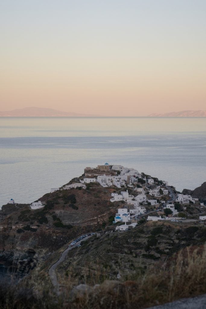 Hilltop village of Kastro above the sea beneath a pastel sky.