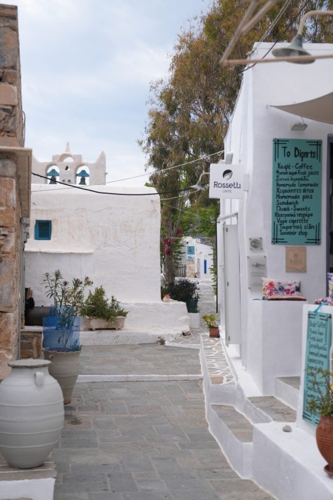 Church bell tower beside a narrow lane in Kastro