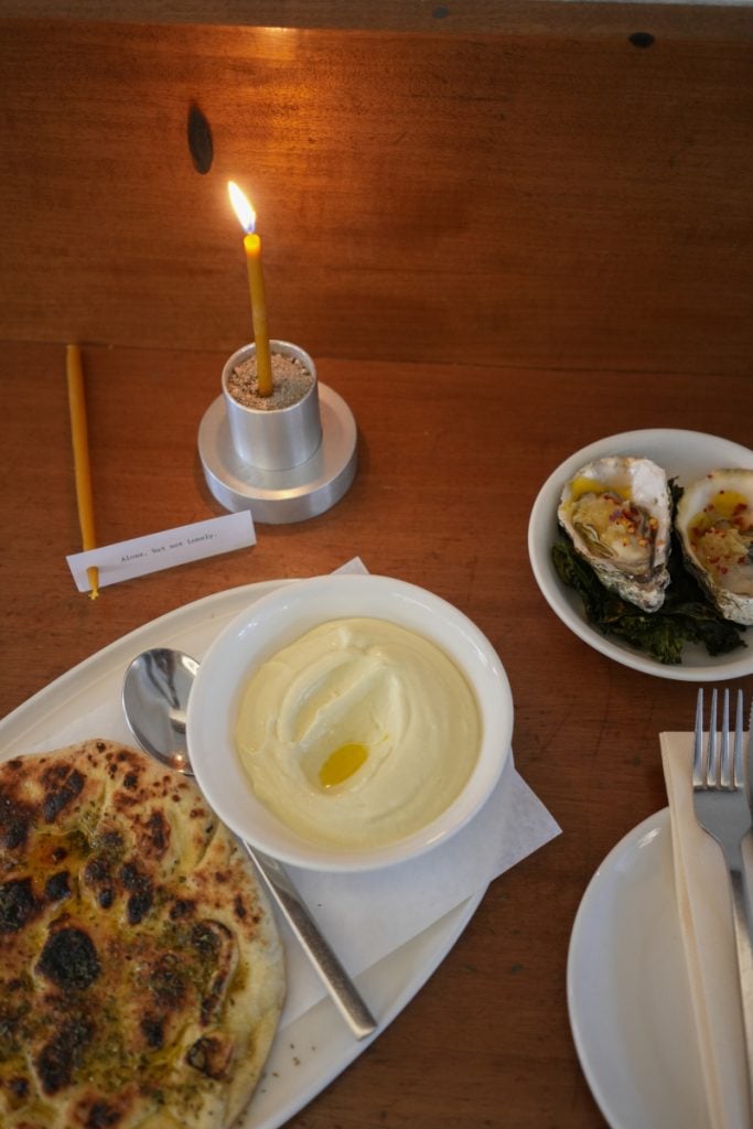 Grilled pita and oysters on a table at LS&SIA