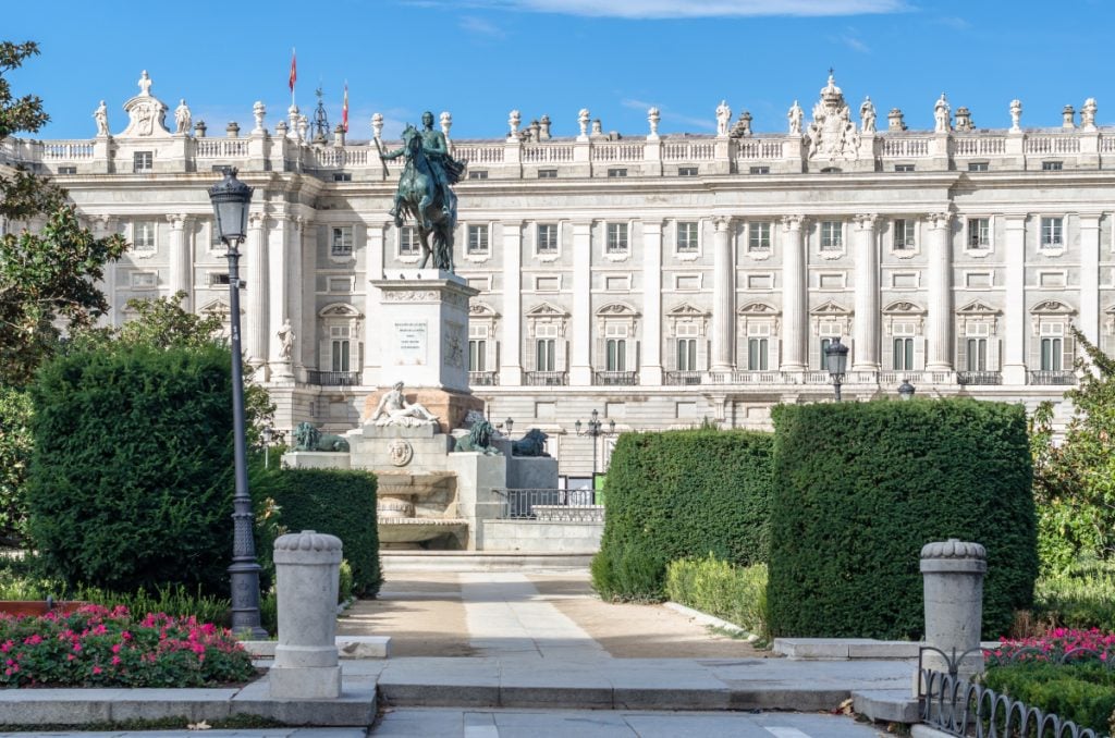 Madrid’s Royal Palace beyond gardens and an equestrian statue