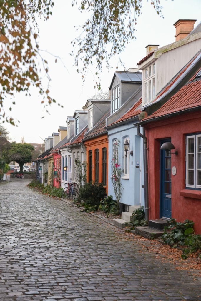 Colorful houses lining cobblestone Møllestien Street