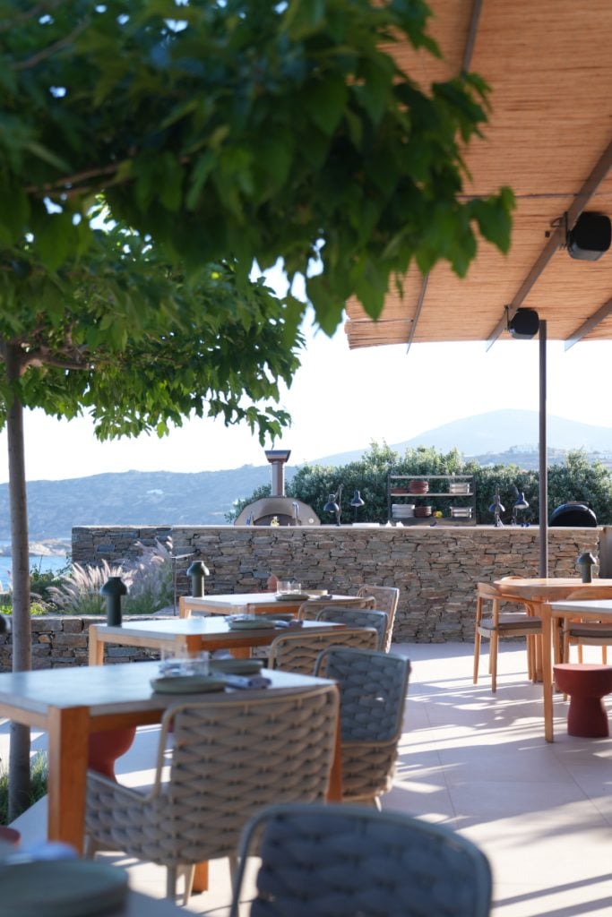 Open-air dining terrace at NŌS overlooking Sifnos hills