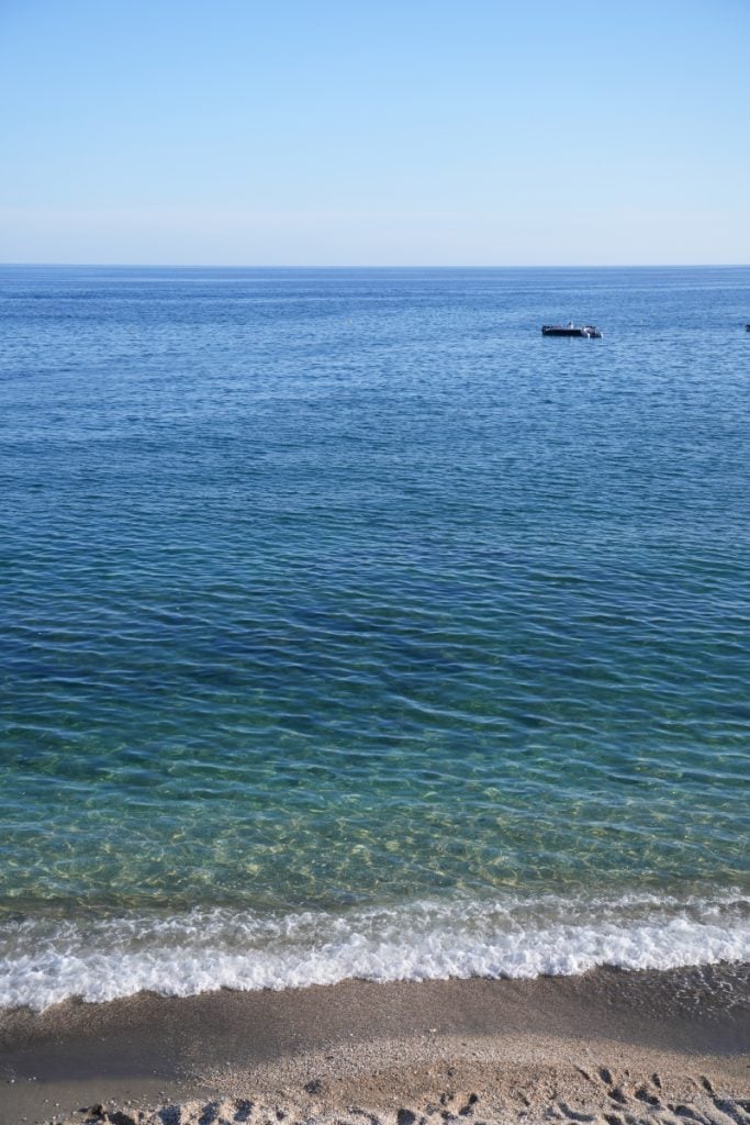 Clear blue water and pebbled shore at Paleochori Beach