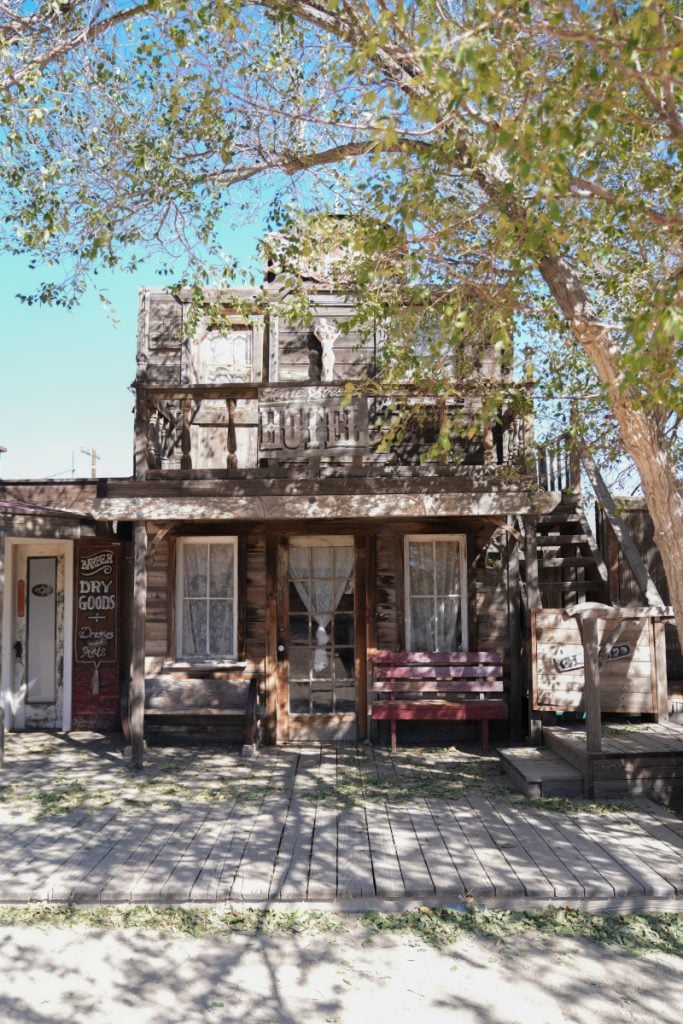 Western-style wooden storefront and shaded porch in Pioneertown