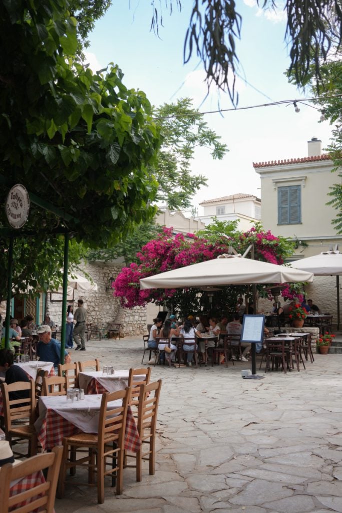 Bougainvillea-shaded restaurant courtyard in Plaka